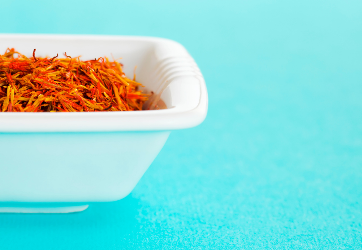 Bowl of Saffron on Blue Background