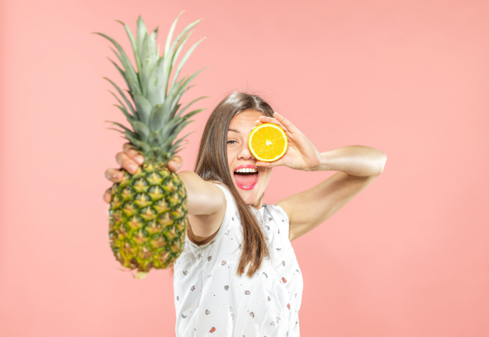 Healthy Woman with Natural Vitamins Pink Background