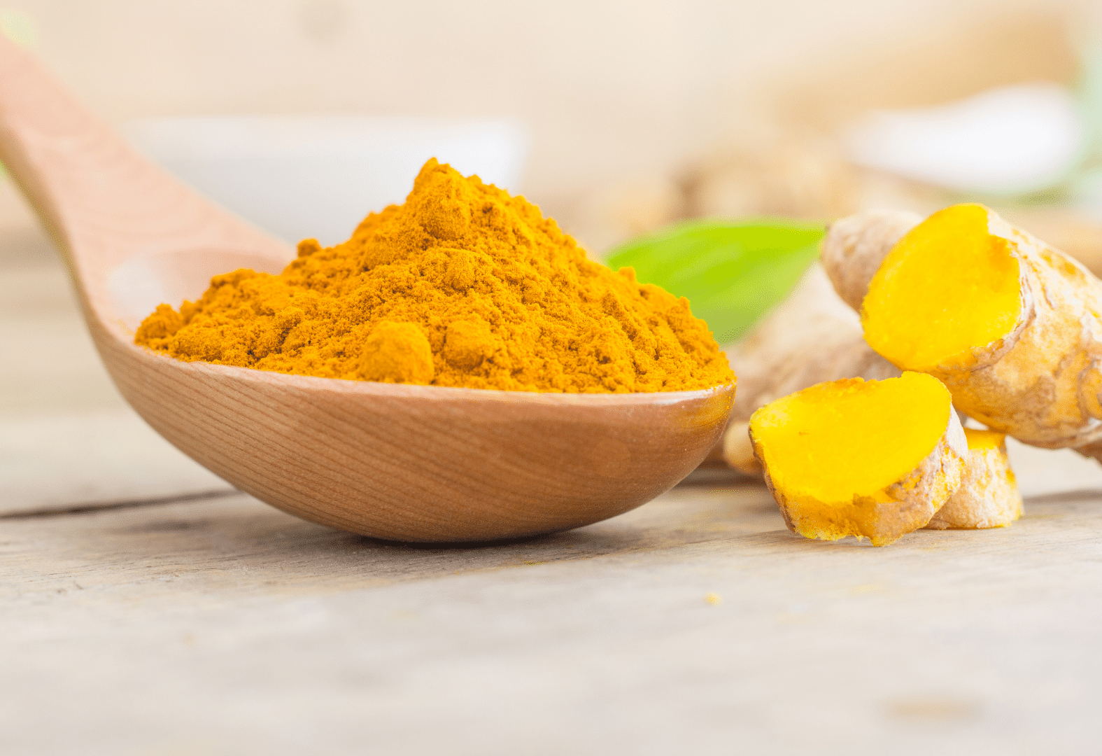 Turmeric in a wooden spoon