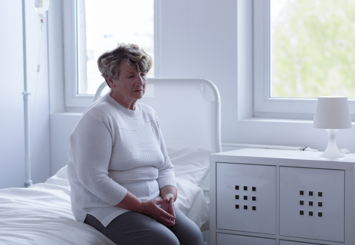 Elderly women sitting a bed